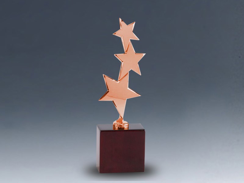 Three bronze stars on wood base